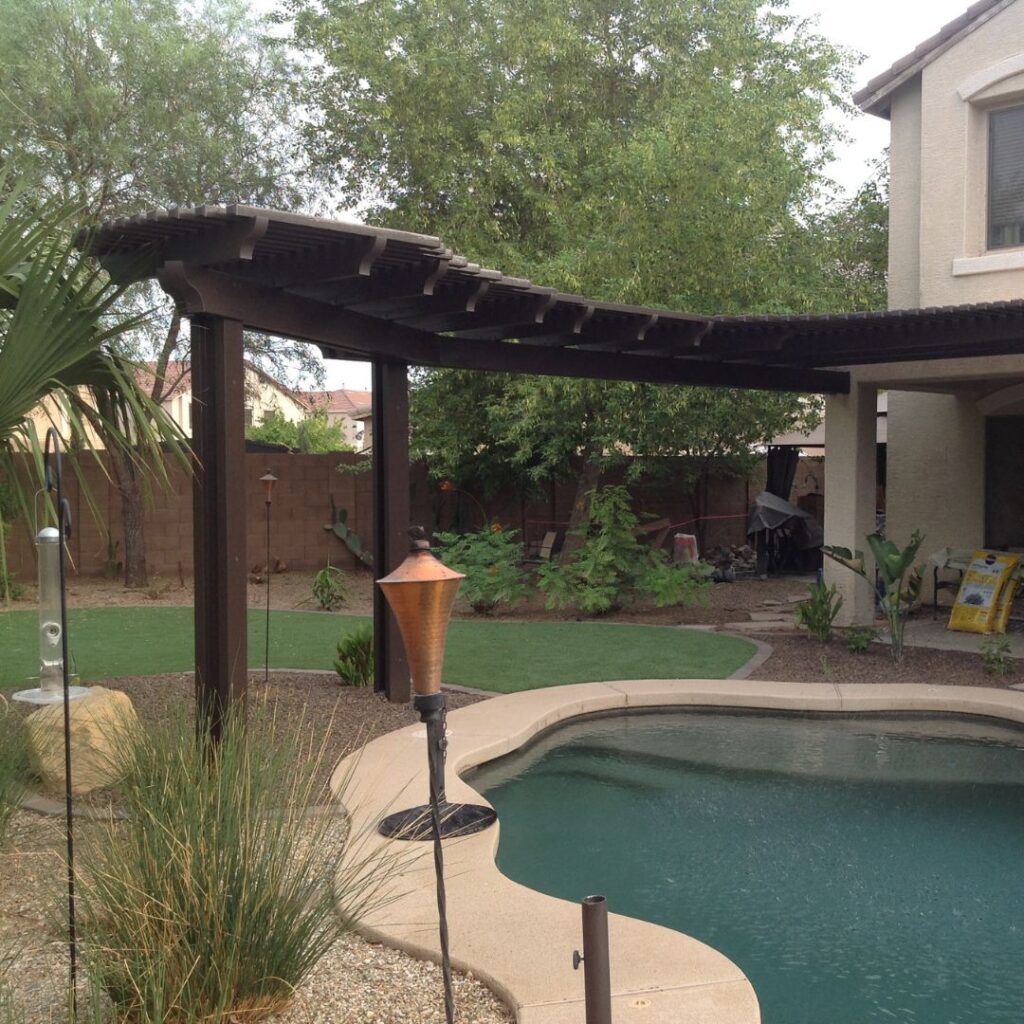 Brown pergola with curved attached lattice cover